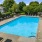 a swimming pool surrounded by chairs