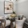a dining table with chairs and a painting on the wall